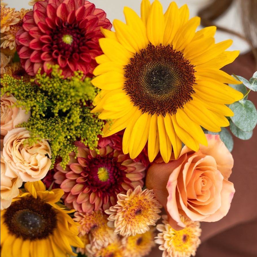 details shot of a fall toned bouquet with sunflowers, dahlias and roses from Lovebird Flowers in London Ontario