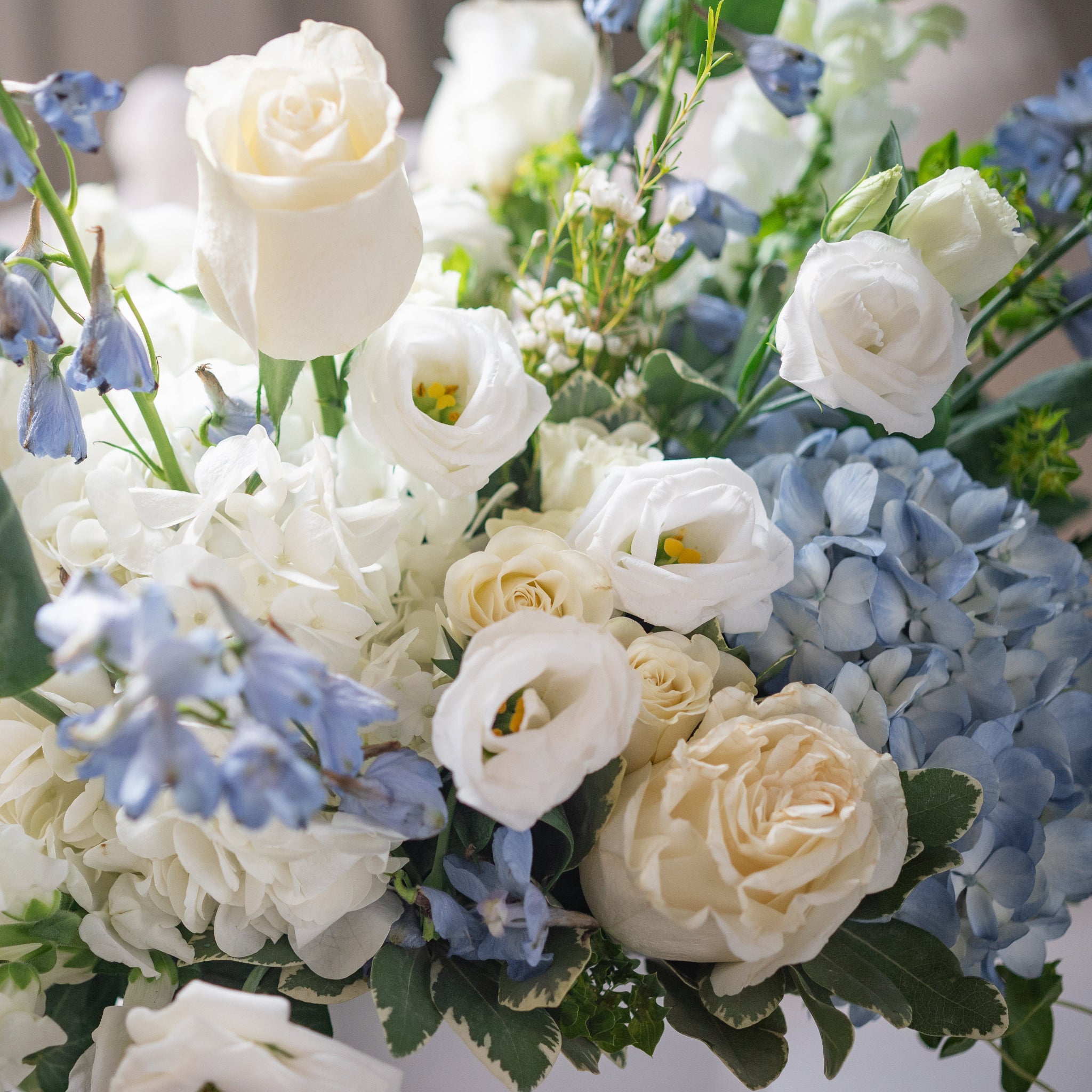 close up of blue hydrangea, white lisianthus, white roses