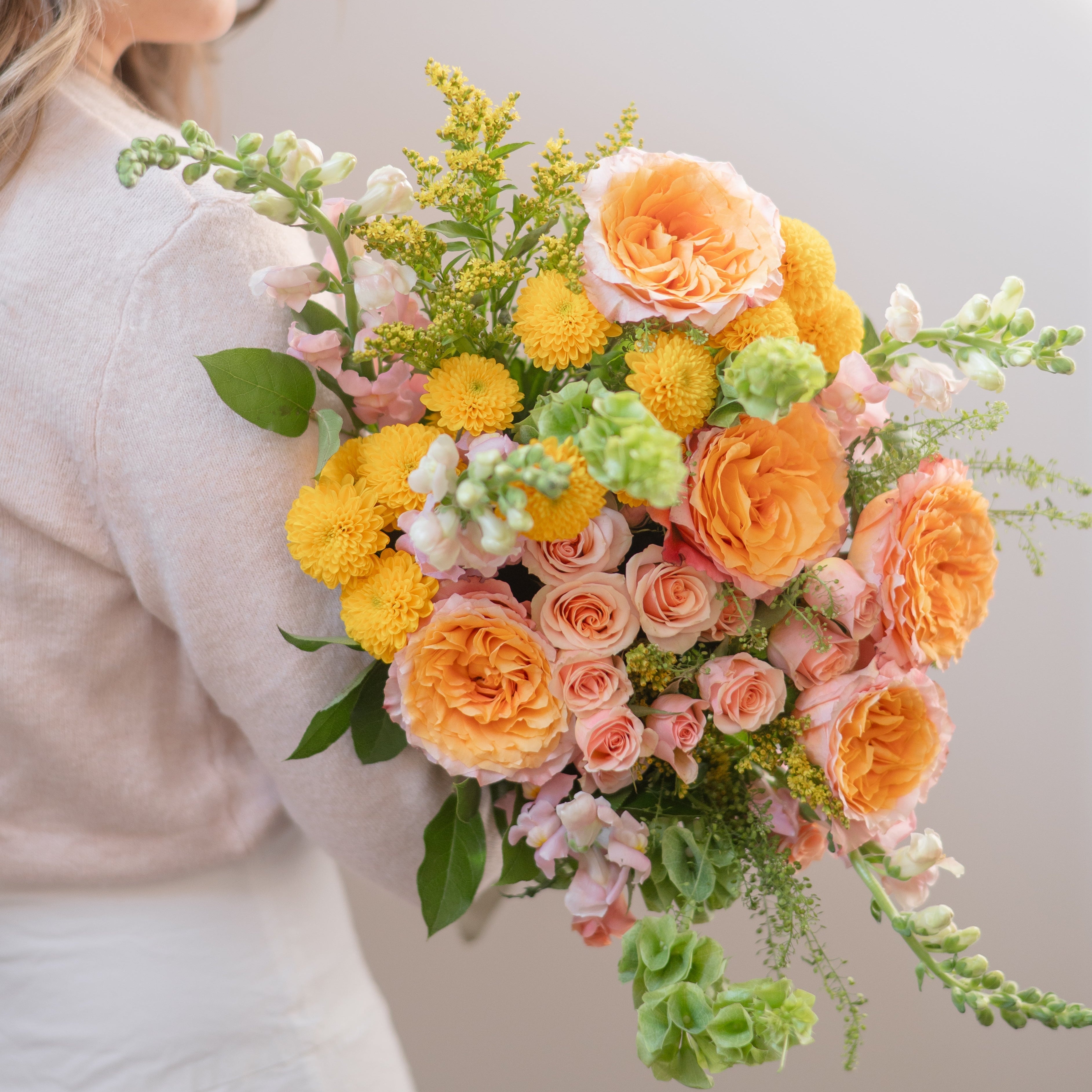 three colourful vase arrangements on a coffee table