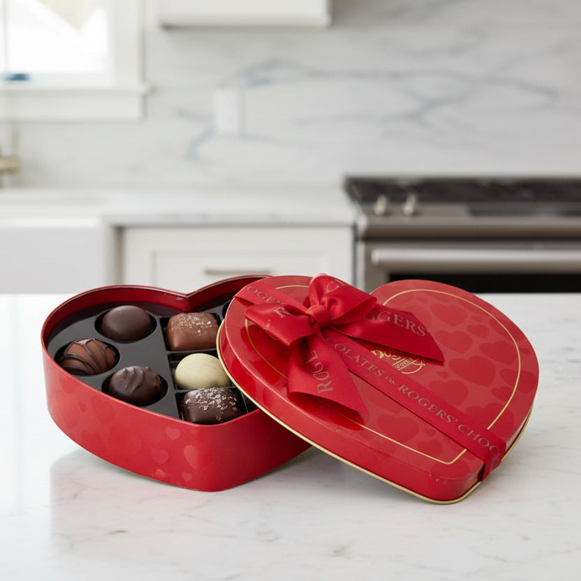 Heart-shaped chocolate box with a bow, featuring Roger's Chocolates branding.