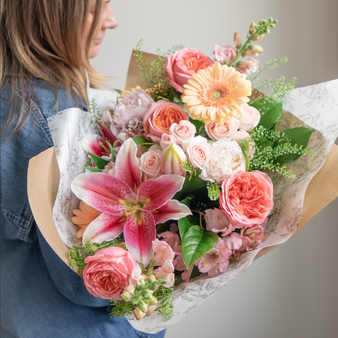 Eternal Love pink sunset bouquet with stargazer lilies, gerbera daisies, roses, peonies and pink snap dragons 