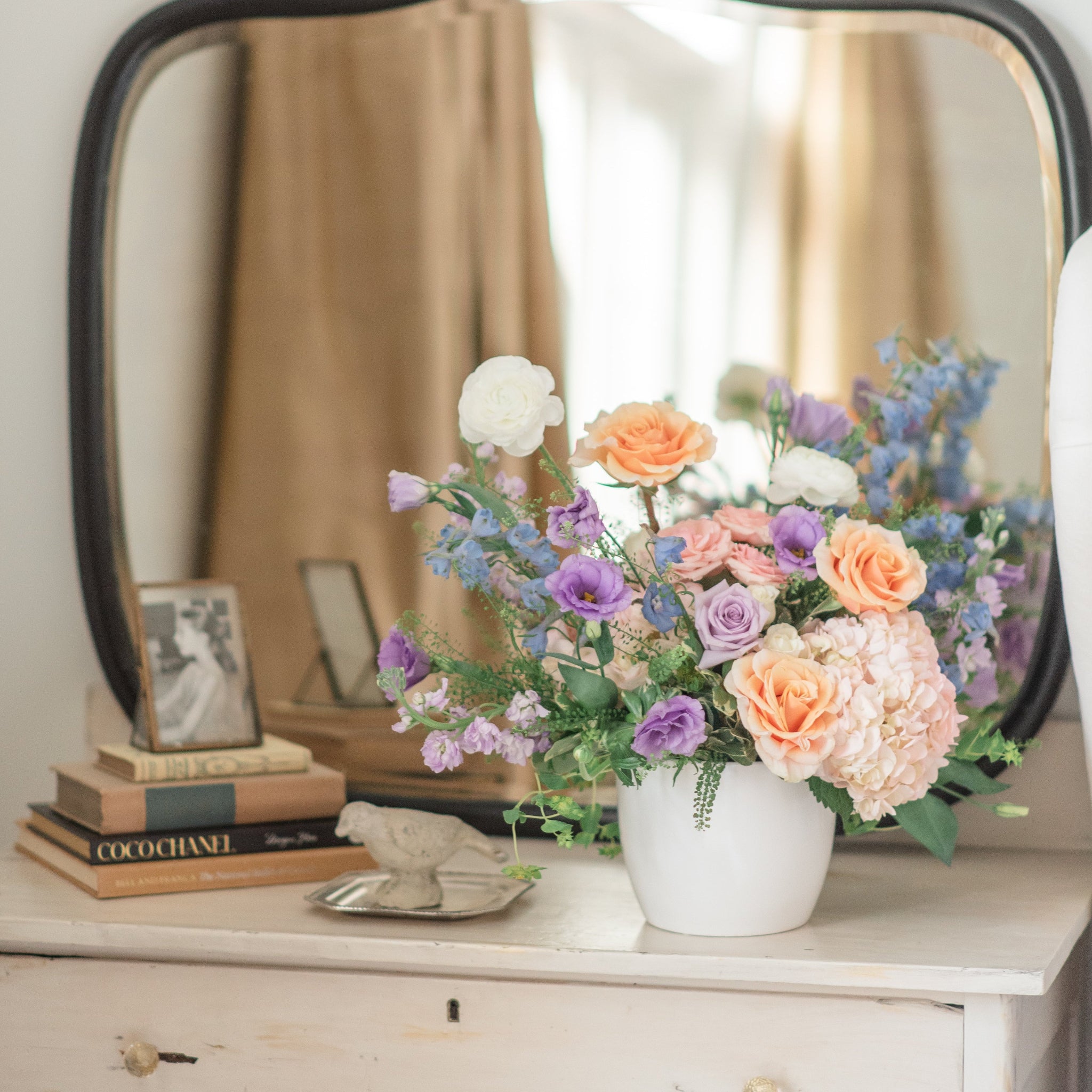 pastel bowl floral arrangement on a side table