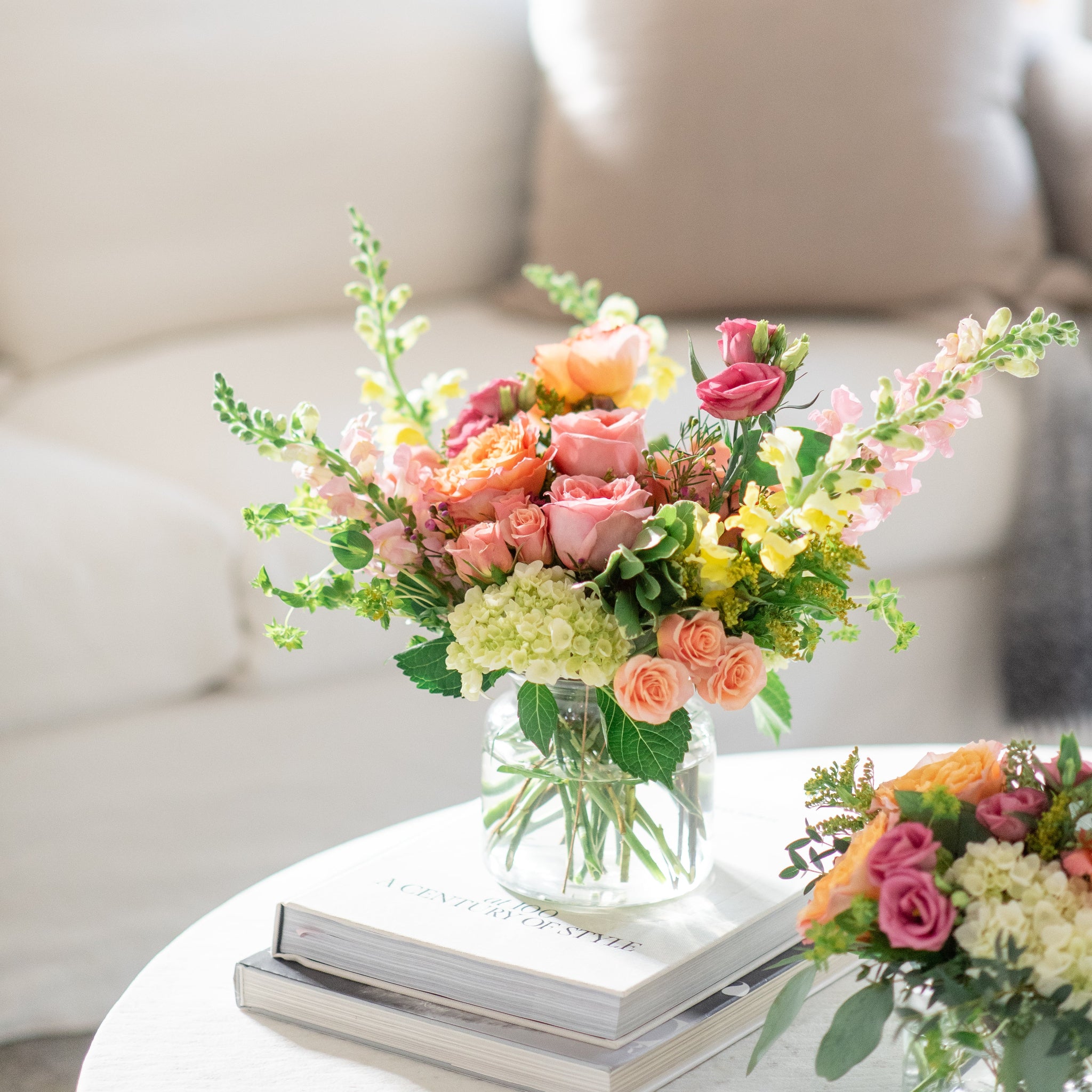 bright pink, orange, yellow arrangement on a coffee table